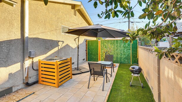 A patio with a table and chairs, a barbecue grill, and a wooden storage unit. - 3 Mi to Angel Stadium: Cozy Studio w/ Patio! (Santa Ana)