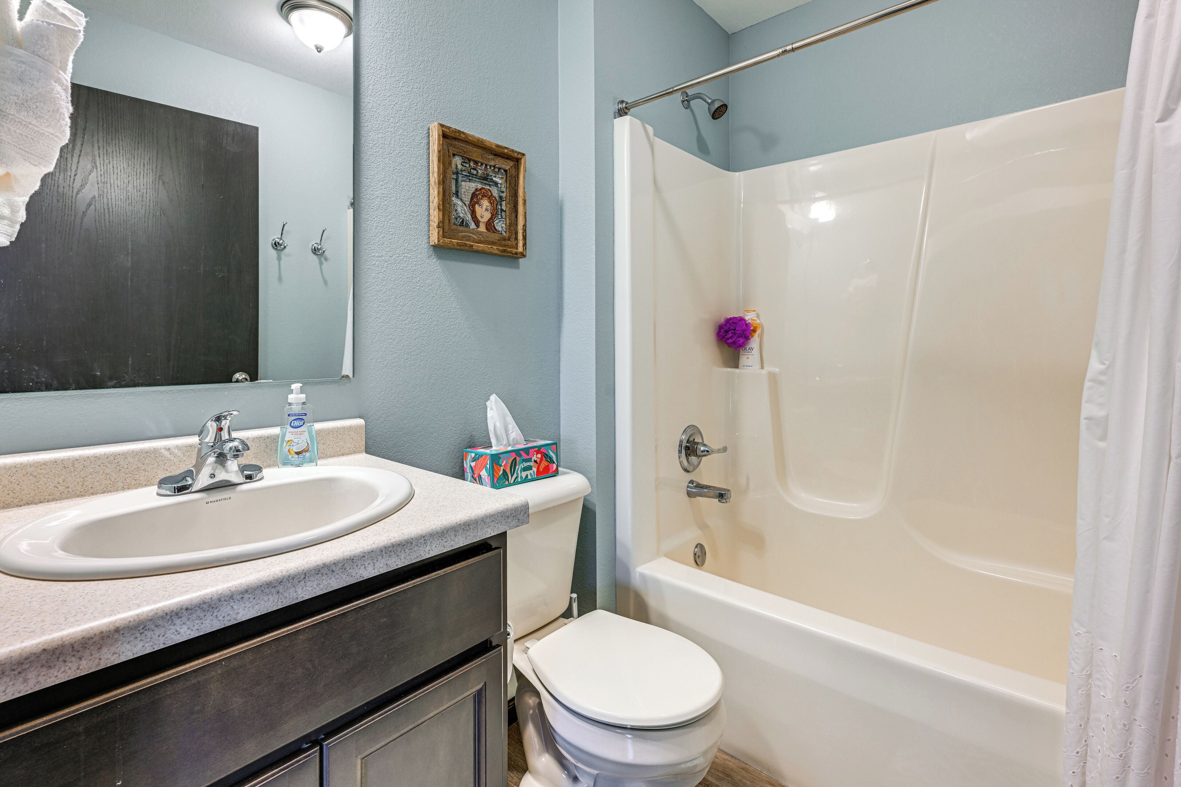 A bathroom with a sink, toilet, and bathtub.