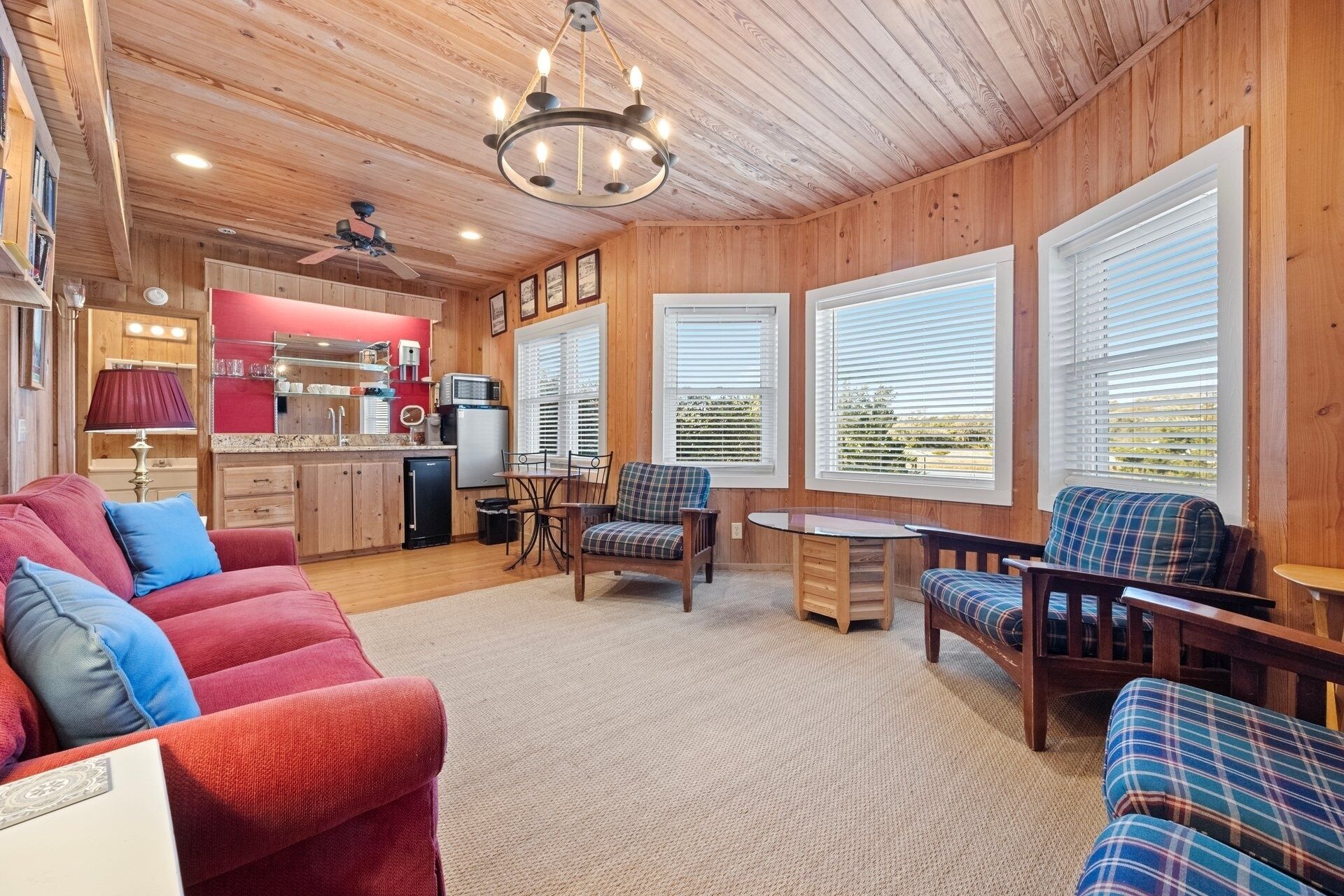 A cozy cabin interior with a kitchen, dining area, and seating.
