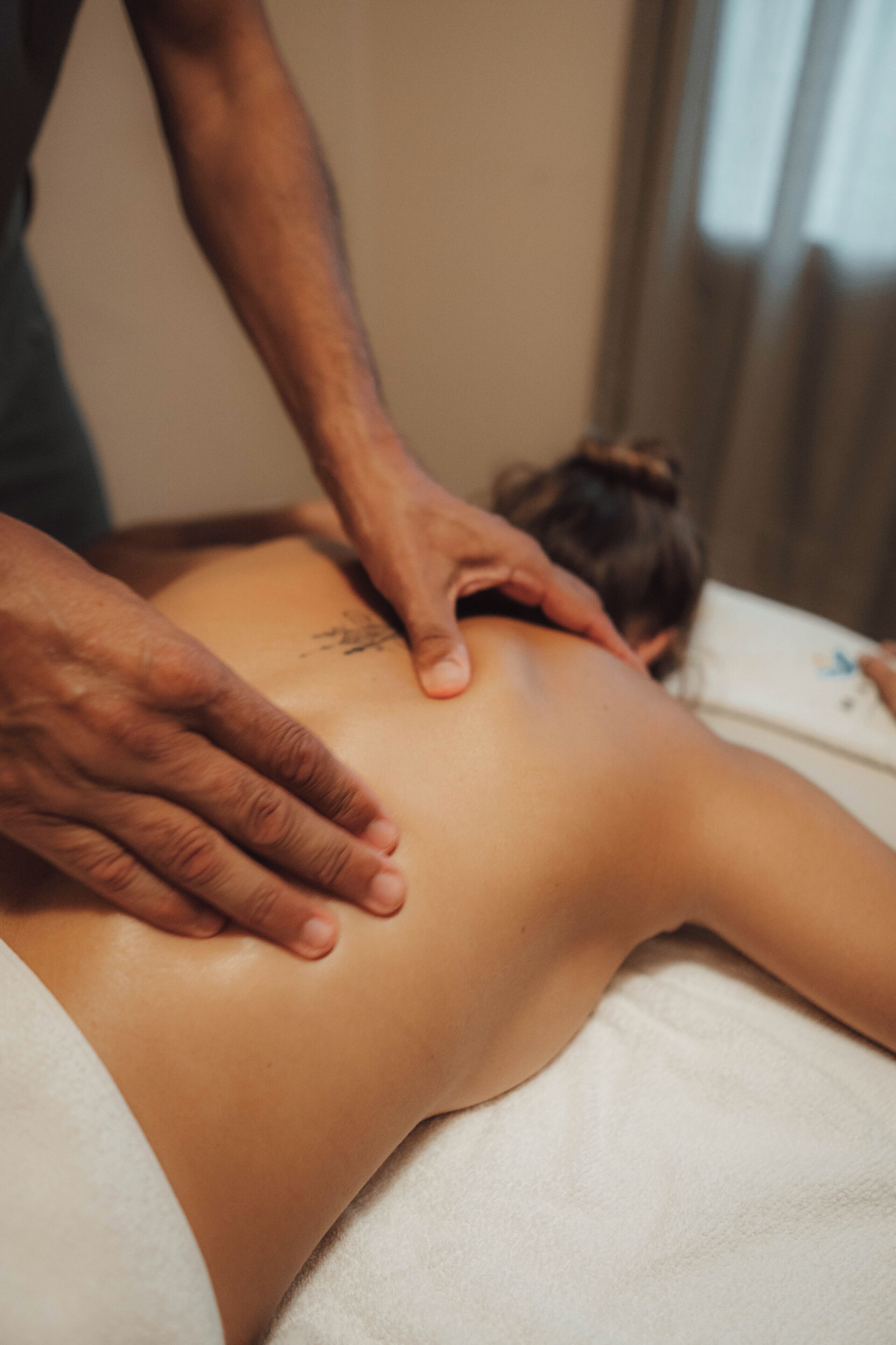 A person receiving a back massage.