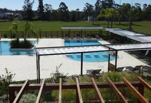 A pool area with multiple pools, sun loungers, and a covered seating area. - Mayim Hotel Termal & SPA (Concordia)