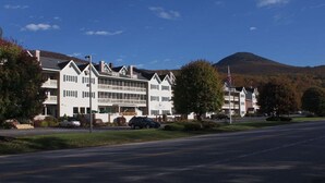 A large, multi-story hotel with a prominent entrance and a flagpole. - # 127 Two Bedroom Condo with private entry (Lincoln)