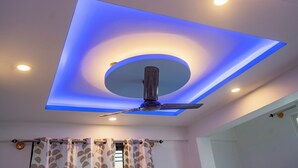 A ceiling with recessed lighting and a central circular light fixture. - VJ Rooms (Bengaluru)