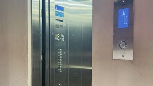 An elevator with a digital display, emergency call button, and a sign indicating OTIS elevator brand. - Om Mandakini Hotel (Kathmandu)
