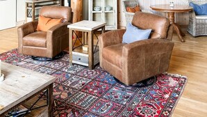 A spacious living area with a high ceiling, exposed wooden beams, a wooden staircase, and a large open-plan layout. - Fabulous cottage suite, spectacular Stoney Lake view! (Douro-Dummer)