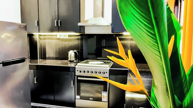 A modern kitchen with a built-in oven, a kettle, and a stove. - Galle Nature Nook (Galle)