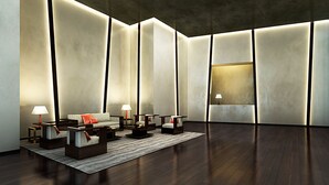 A modern lobby with a sofa, chairs, and a coffee table. There are lamps on side tables and a rug on the floor. - Century Spire (Makati)