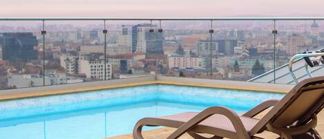 Outdoor pool, open 8:00 AM to 10:00 PM, sun loungers