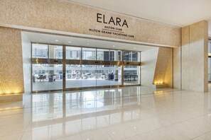 Welcome to the Elara Hilton Club, featuring a modern design and a spacious outdoor seating area.
