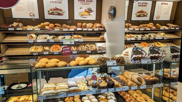 A bakery display with various baked goods and price tags. - Apart Hotel Neudörfl (Neudoerfl)