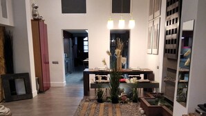 A spacious living room with a large rug, a dining table, and a seating area. - MONUMENT, large, cosy apartment (Barcelona)