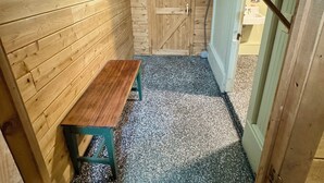 A wooden interior with a bench, a door, and a small window. - Spacious 7-bedroom house with WiFi, Garage, Sauna, and AC in amazing Calumet (Calumet)