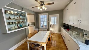 A kitchen with a dining table, chairs, and cabinets. - Spacious 7-bedroom house with WiFi, Garage, Sauna, and AC in amazing Calumet (Calumet)