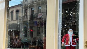 A storefront with large windows displaying a Santa Claus figure and string lights. - hotel golden star (Batumi)