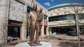 A statue of a man and a child in front of a modern building with a blue dome and a checkered facade. - Cozy 1 Bed, 1 Bath - Near Downtown and U of U. (Salt Lake City)