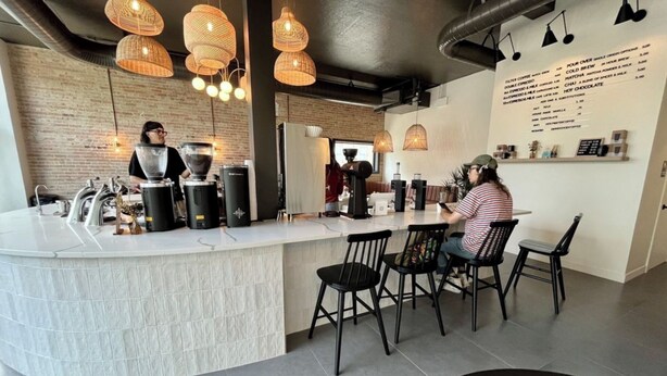 A modern coffee shop with a counter, baristas, and seating area. - Cozy 1 Bed, 1 Bath - Near Downtown and U of U. (Salt Lake City)