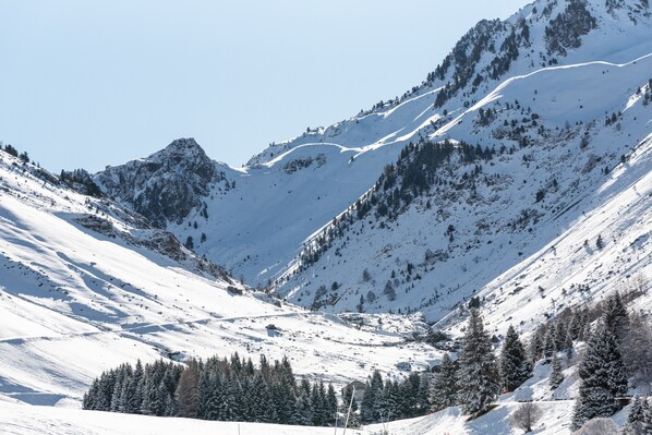 A snow-covered mountain landscape with a clear sky.