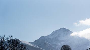 A snow-covered mountain with a clear sky.