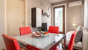 A modern kitchen with a refrigerator, microwave, and a coffee machine on the countertop.
