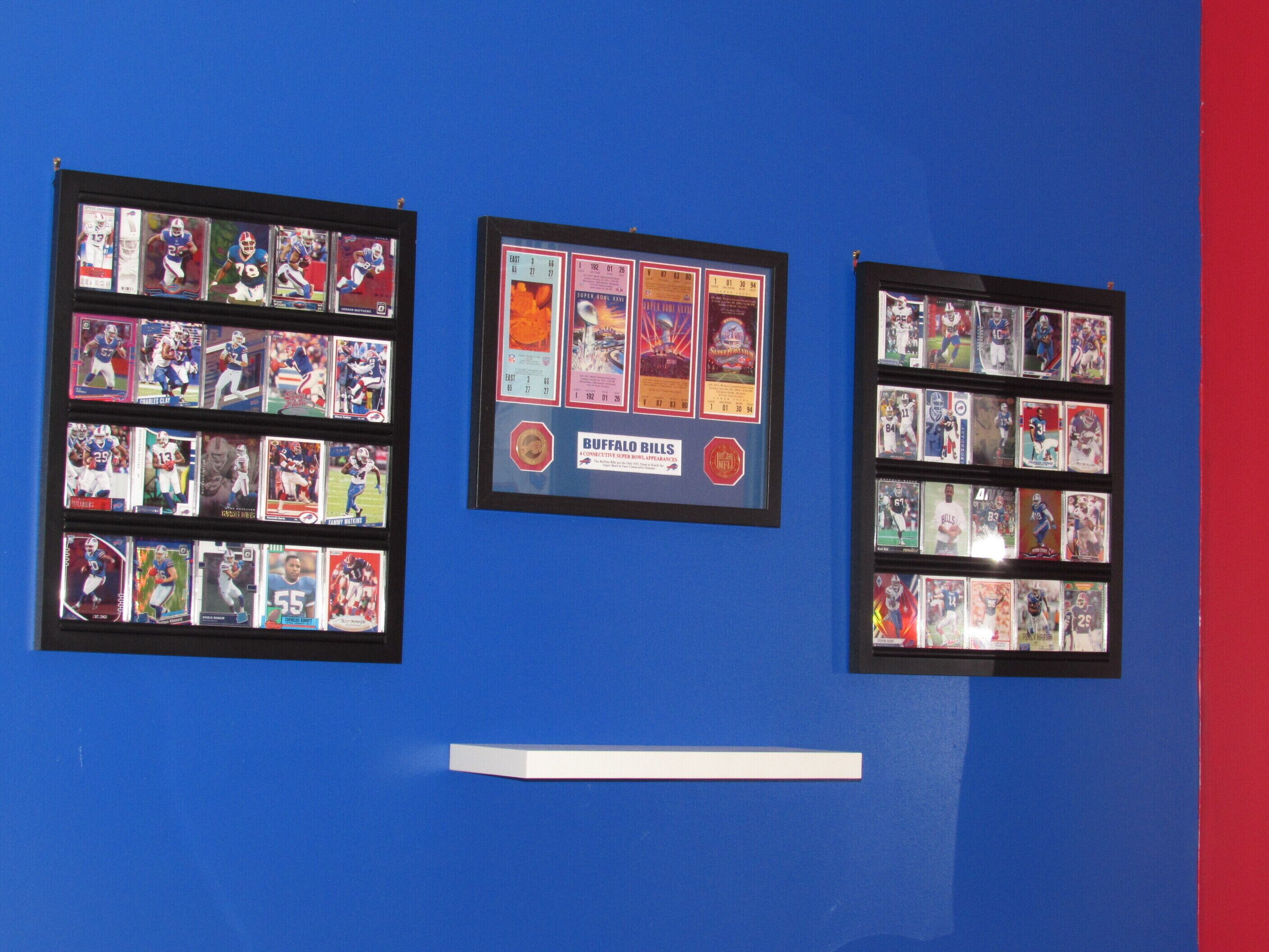 Three framed sports card displays on a blue wall.