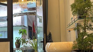 A modern bathroom with a marble countertop, a large mirror, and a potted plant. - Homestay Ngô Khánh 1 (Da Nang)