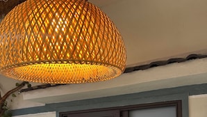 A room with a large window, a wall-mounted sign with text, and a hanging light fixture. - Homestay Ngô Khánh 1 (Da Nang)