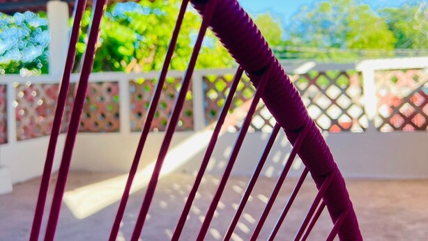 A hammock with purple ropes under a red-tiled roof. - Casa Chulibul located in downtown Merida, a fusion of tradition and comfort. (Centro)