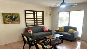 A living room with two sofas, a coffee table, and two rocking chairs. - Casa Chulibul located in downtown Merida, a fusion of tradition and comfort. (Centro)