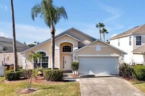 A residential house with a garage, a driveway, and palm trees. - Magical Disney Retreat | Lake Berkley Resort & Pool (Kissimmee)