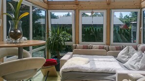 A cozy room with a bed, a table with a vase, and a chair. - Nice home in Fohnsdorf with sauna (Fohnsdorf)