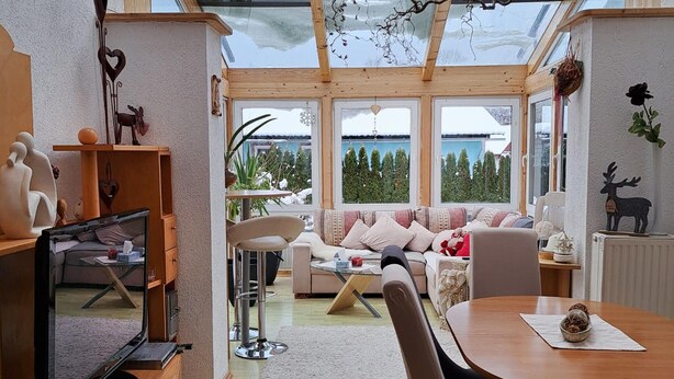 A cozy living room with a sofa, chairs, a dining table, and a TV. - Nice home in Fohnsdorf with sauna (Fohnsdorf)
