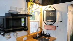 A compact kitchen with a microwave, sink, and wooden countertop. - Charming Backyard Studio/Tiny Home in beautiful Jacksonville/OP  (Jacksonville)