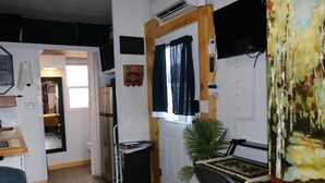 A compact living space with a kitchenette, a dining area, and a small seating area. - Charming Backyard Studio/Tiny Home in beautiful Jacksonville/OP  (Jacksonville)