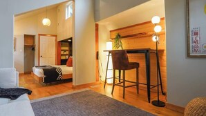 A room with a bed, a desk, a chair, a lamp, and a plant. - Cozy Mt. Baker Escape • Fireplace • Pets (Glacier)