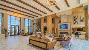 A spacious lobby with a high ceiling, large windows, and a modern chandelier. - ROVE LIVING/KL - Alta North Central (Phoenix)