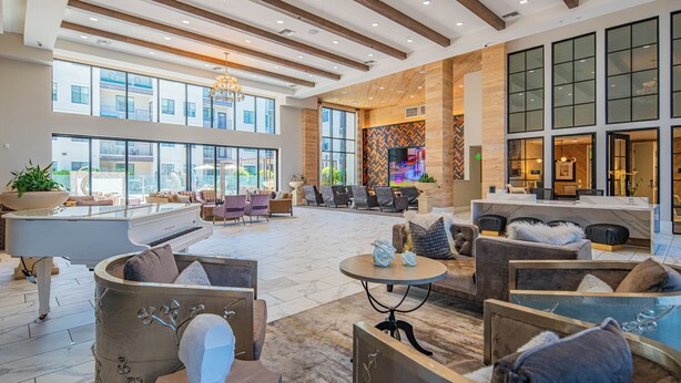 A spacious lobby with a grand piano, comfortable seating areas, and large windows offering views of the outside. - ROVE LIVING/KL - Alta North Central (Phoenix)