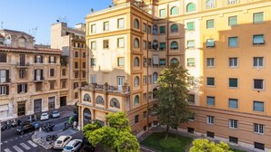 A multi-story building with a classic architectural style, featuring balconies and large windows.