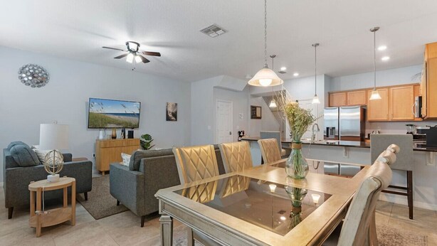 A modern living room with a dining table, sofas, and a kitchen in the background. - Family House near Disney - 5109 (Kissimmee)