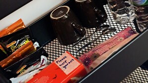 A tray with tea bags, water bottles, and a tray liner. - The Red Room @ Alanis Residence Sepang, KLIA1 and KLIA2 (Sepang)