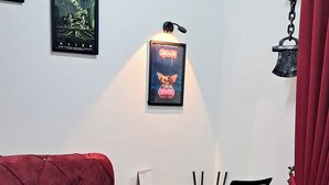 A bedroom with a bed, a desk, and a chair. There are posters on the wall and a curtain. - The Red Room @ Alanis Residence Sepang, KLIA1 and KLIA2 (Sepang)