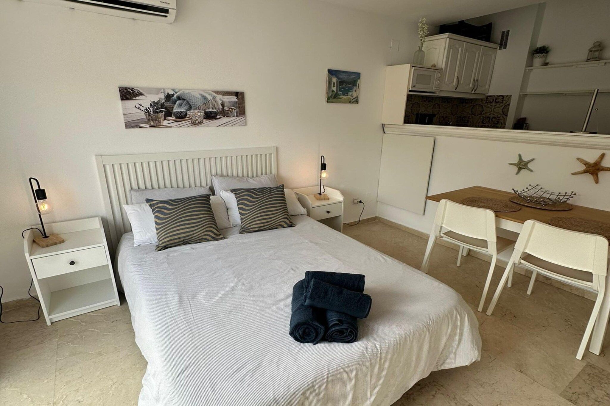 Ein Schlafzimmer mit einem Bett, Nachttischen, einem Schreibtisch und einem Stuhl.