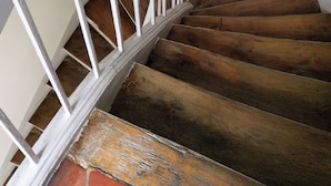 A spiral staircase with wooden steps and white railings. - Le Marais St.Paul Mobility lease apartment  (Paris)