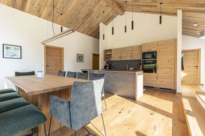 Enjoy meals in the kitchen with a central island and oven, and dine at the long table with comfortable chairs.