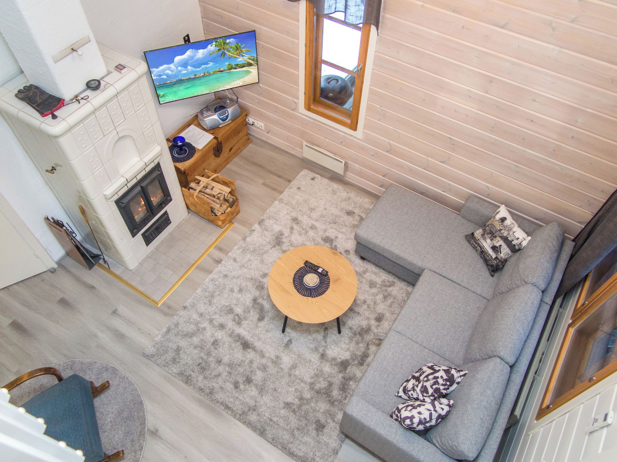 A cozy living room with a fireplace, a television, a sofa, and a coffee table.