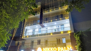 A multi-story building with a sign reading "Nikko Palm." - Nikko Palm Near Huda City Centre (Gurugram)