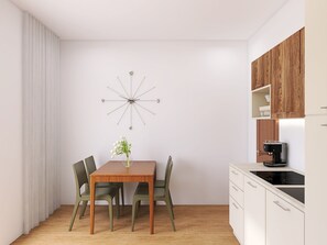 A modern kitchen with a dining table, chairs, a clock, and a coffee machine. - Apartment Villa in Limone Sul Garda (Limone sul Garda)