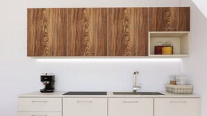 A modern kitchen with wooden cabinets, a coffee machine, a sink, and storage jars. - Apartment Villa in Limone Sul Garda (Limone sul Garda)