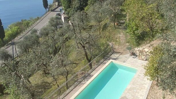 Une piscine avec vue sur la mer et un paysage montagneux.