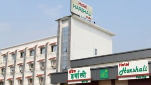 A hotel named 'Hotel Harshal' with a sign indicating 'Hotel Harshal' and 'Park'. - Hotel Harshali Residency (Khalapur)