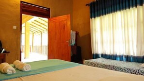 A room with a wooden ceiling, a bed with white bedding, a ceiling fan, and a window with blue curtains. - Sinharaja Eco Lodge  (Neluwa)